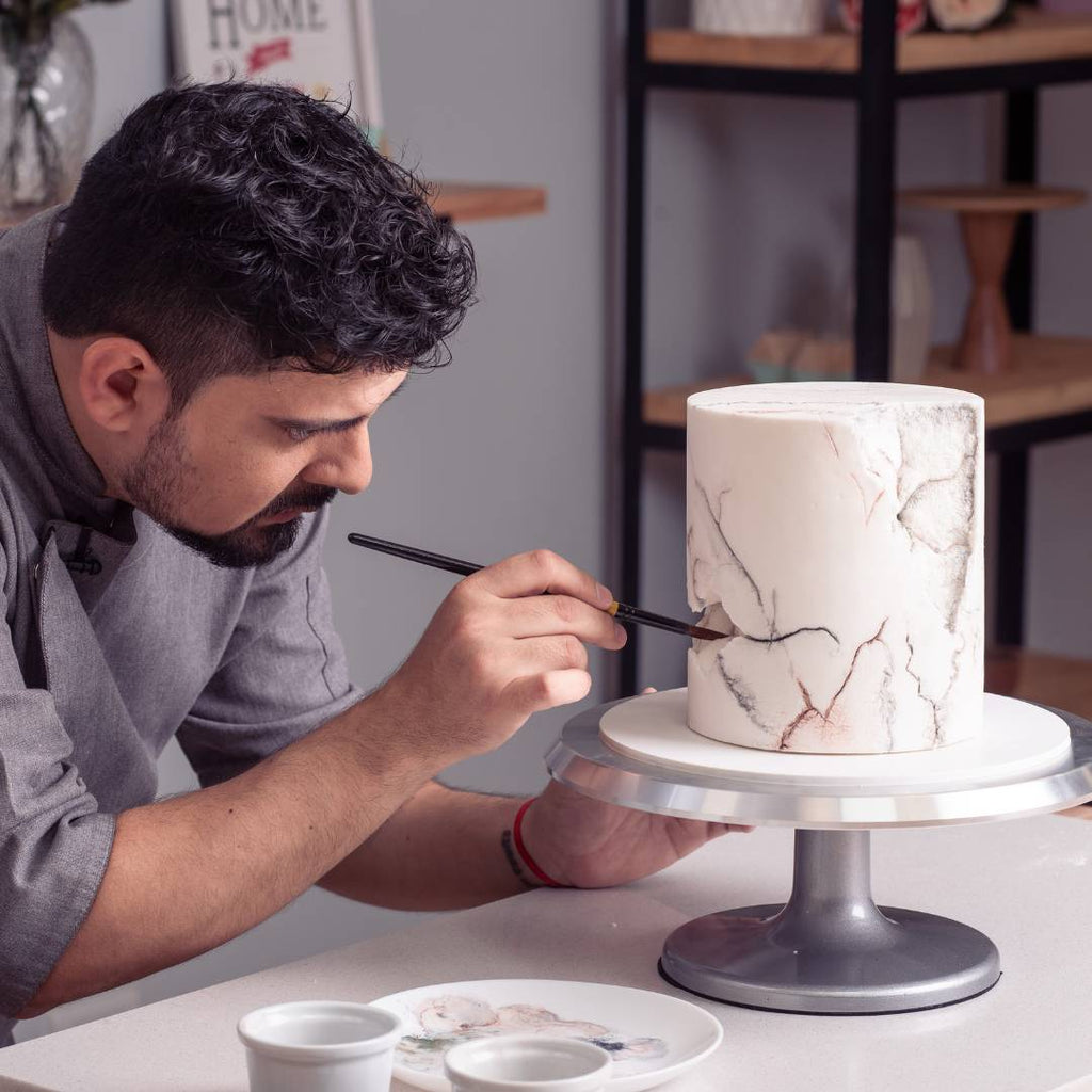 Chef Leonardo pintando pastel con pincel